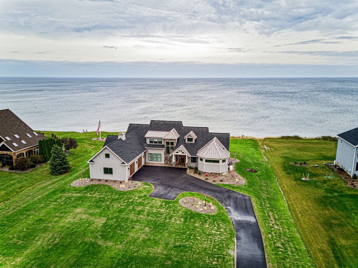 Drone view of luxury lakefront home near Rochester by Gerber Homes